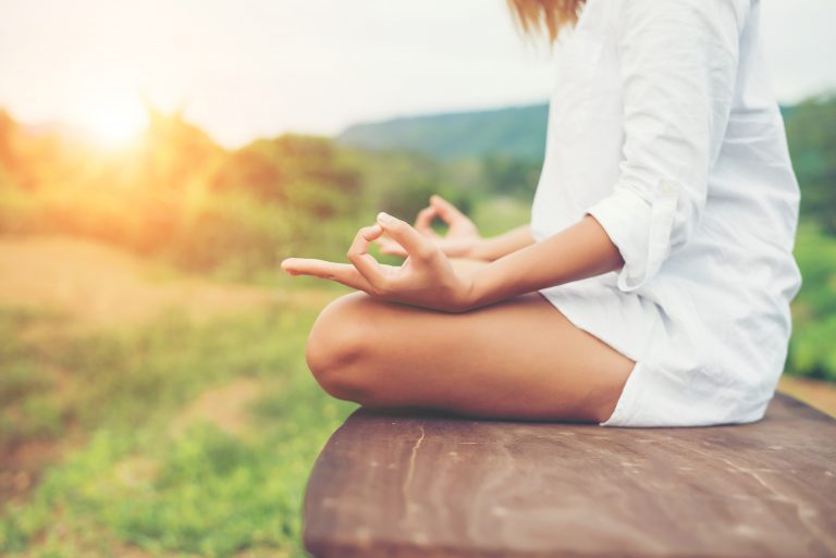 Woman hands yoga meditations and making a zen symbol with her hand.